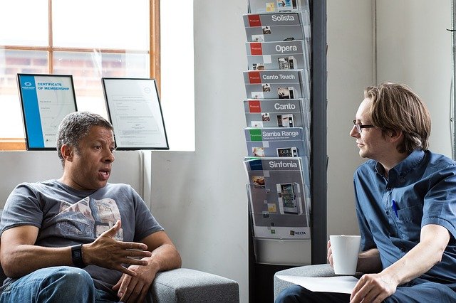 Two men talking to build a successful mentoring relationship.