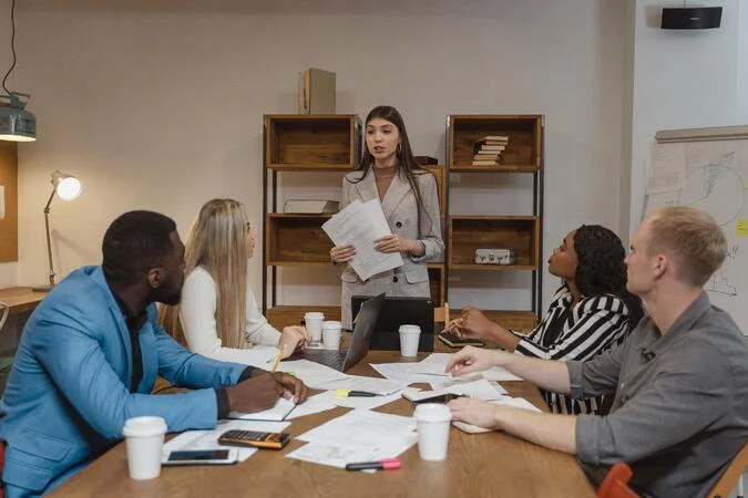 Group meeting around a table for leadership development.