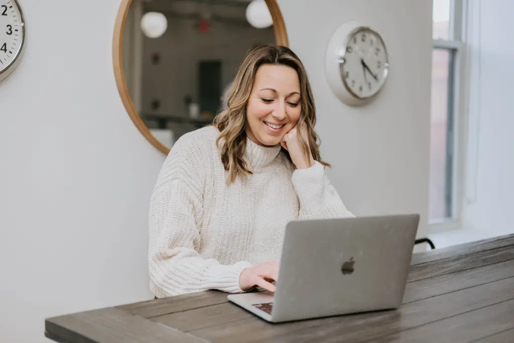 A woman sitting at a computer in an office as she explores career options.