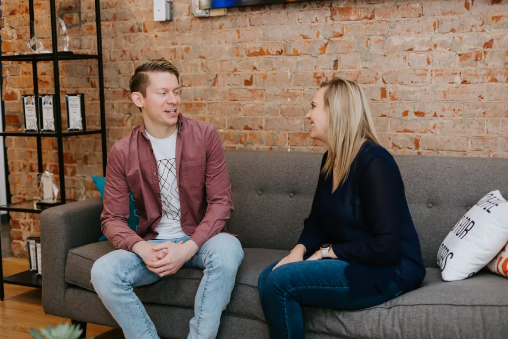 Man and women talking on a cough in an office.