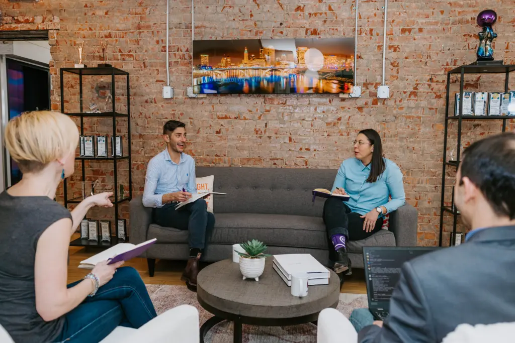 A group of employees in a mentor training session sitting in an office.