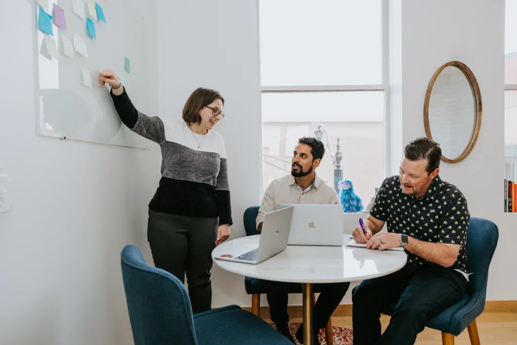 Group of employees in a conference room discussing career development options.