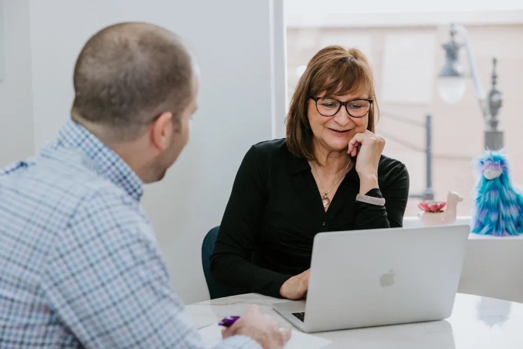 Man and woman talking and coaching for job interviews in the office.