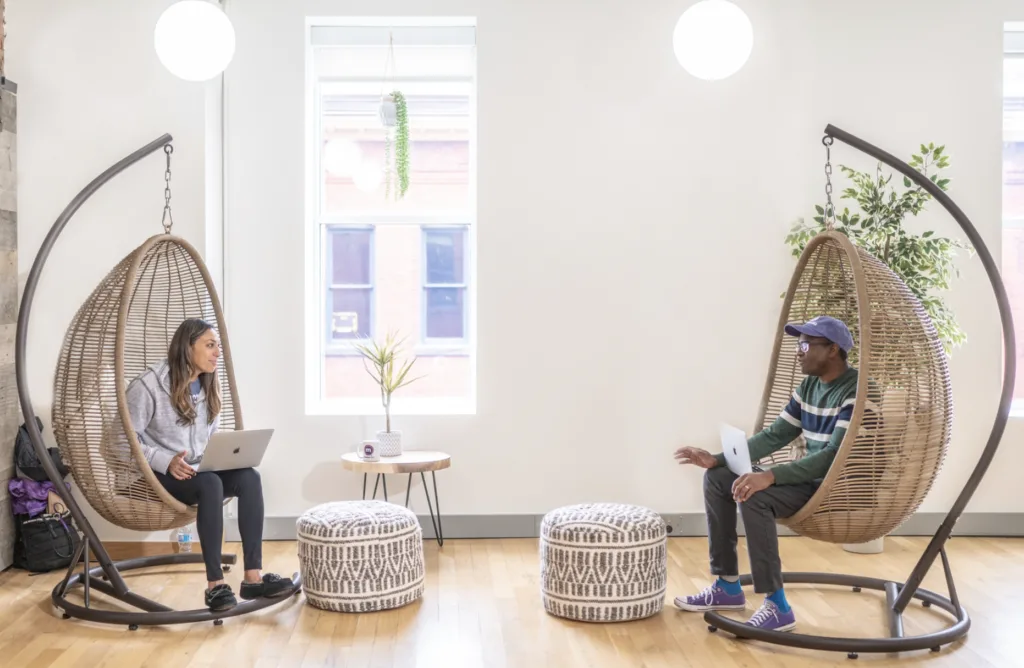 Engaging with mentorship at the office in hammock chairs.