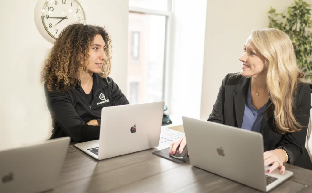 Employee development through knowledge sharing between two female employees.