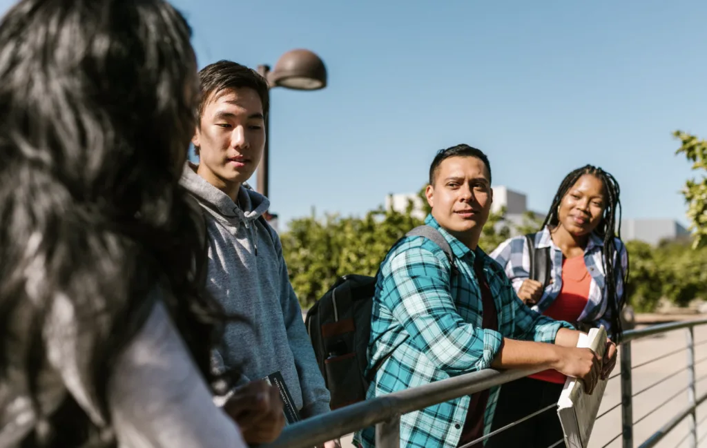 First-gen college students standing on path and talking. 