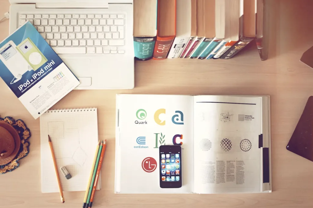 An organized desk with books, pencils, and a computer to display how neurodiveristy in the workplace can require help with organization 